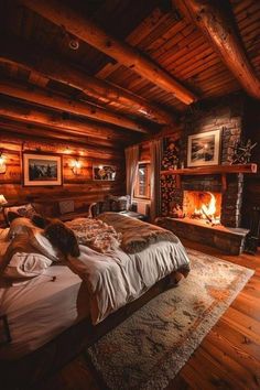 a bed in a room with wood walls and a fire place on the wall next to it