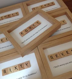 four scrabble tiles with words that spell out the word forty seventy seven, six twenty and seven