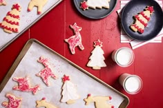 cookies decorated with icing and sprinkles sitting on top of a table