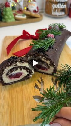 a person is cutting up some food on a wooden board with christmas decorations in the background