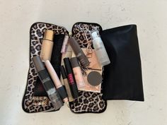 the contents of a leopard print travel case