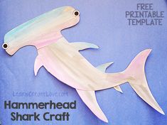 a paper cut out of a hammerhead shark on a blue background with free printable template