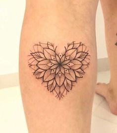 a woman's leg with a tattoo design on the lower part of her thigh