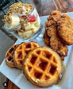 fried chicken, waffles and fruit on a plate