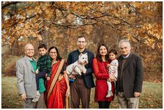 a family posing for a photo in front of a tree