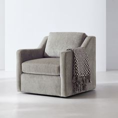 a gray chair with a black and white blanket on it's armrests