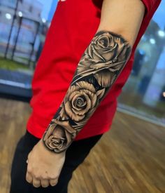 a man with a rose tattoo on his arm