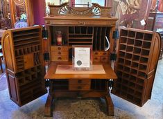 an old fashioned desk and bookcase in a store