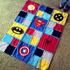 a quilt made to look like superheros on the floor with text that reads make a quilt from tee shirts