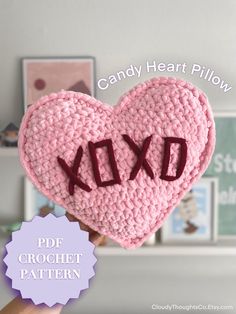 a pink crocheted heart with the word xo on it