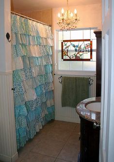 a bathroom with a shower curtain, sink and toilet