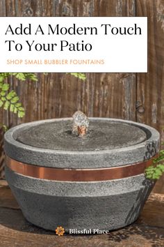 a potted planter sitting on top of a wooden table next to a fence