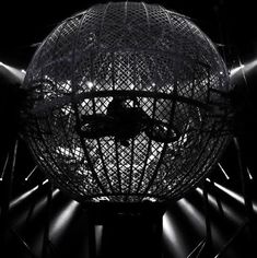 a black and white photo of a disco ball in the middle of some lights that are shining down on it