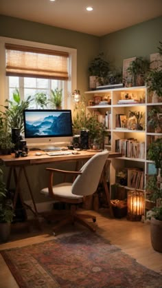 a desk with a computer on top of it in front of a window and potted plants