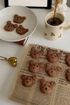 there are some cookies on the table next to a cup of coffee