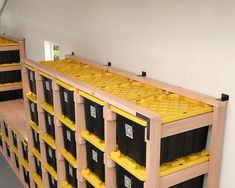 the shelves are filled with yellow and black containers