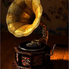 an old phonograph sitting on top of a wooden table