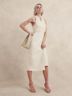 We reimagined the silhouette of a timeless wrap dress for warm weather, cutting it in a draped, v-neck and a fixed, wrap-effect front.  For fabric, we reached for a luxurious silk-linen fabric—one we love for its subtle slub texture.  Fit & Flare: Fitted through the chest, defined waist, A-line skirt.  Draped v-neck.  Wrap-effect front.  Invisible zip at wearer's left.  Fully lined.  Fit & Flare: Fitted through the chest, defined waist, A-line skirt.  Sleeveless.  Midi length.  Model: Size 2, 5'10" (178cm). Ivory Midi Dress, Fabric Draping, Pretty Clothing, Defined Waist, Silk Tulle, Dress Cream, In Focus, Silk Linen, Silk Wool