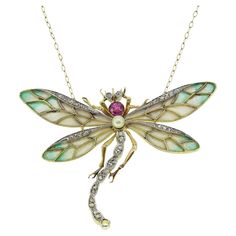 Here we have an outstanding necklace crafted during the pinnacle of the Art Nouveau movement. This rare and unique piece has been curated from a warm 18ct yellow gold into the shape of a dragonfly and displays a breathtaking use of the plique-a-jour enamelling method. The French word plique-a-jour translates to "letting in daylight”; it is a technique used dating back to 6th century AD. This method could take up to a few months to finish and is a very difficult and arduous process. During the Ar Art Deco Pendant Necklace, Art Nouveau Necklaces, Art Nouveau Pendant, Dragonfly Wings, French Word, Nouveau Jewelry, Antique Jewelry Necklace, Dragonfly Necklace, Art Deco Pendant