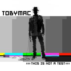 a man standing in front of a tv screen with the words, tobymac this is not a test