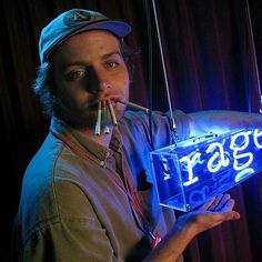 a man is holding an electronic device in his hand with the word air on it