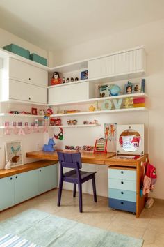 a child's desk and chair in the corner of a room with lots of shelves