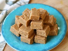 a blue plate filled with peanut butter fudges on top of a wooden table