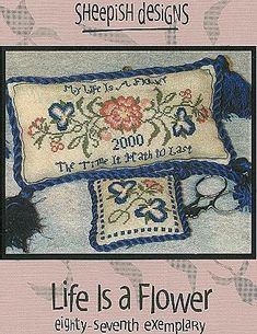 a cross stitch pattern with the words life is a flower on it and an embroidered pillow