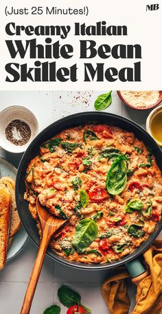 a skillet with white bean and spinach in it, next to some bread