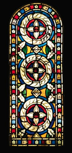 an ornate stained glass window with many different colors and designs on the front, side and back