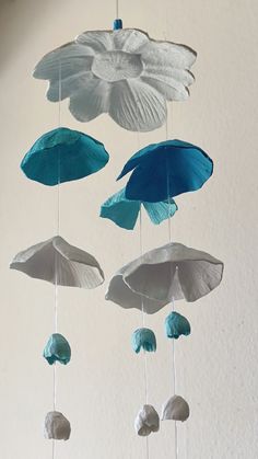 a group of blue and white umbrellas hanging from the side of a wall in a room