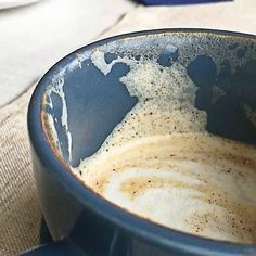 a blue bowl filled with liquid on top of a table