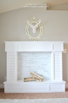 a white fireplace in a living room with a cow head on the mantle