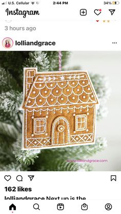 a gingerbread house ornament hanging from a christmas tree with the words instagram