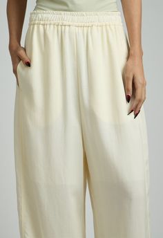 One size. Fits XS-MColor: CreamLightweight FabricDrawstring Waist100% TencelDry Clean By The NKC StoreProduct Measurements:Waist: 66.04cm / 26in Length: 104.77cm / 41.25in White Bottoms With Gathered Waist For Spring, White Rayon Bottoms For Summer, Elegant Bottoms With Gathered Waist For Daywear, Relaxed Fit Bottoms With Gathered Waist, White Bottoms With Gathered Waist For Summer, Cream Tapered Leg Pants With Elastic Waistband, Cream Tapered Leg Summer Bottoms, Cream Tapered Leg Summer Pants, Summer Pants With Gathered Waist And Loosely Fitted Hips