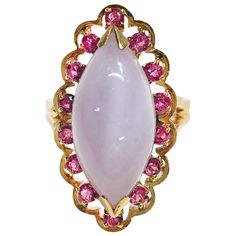 14 Karat Lavender Jade Ruby Navette Cocktail Ring. The ring features a lavender jade marquise cabochon measuring 21.1 x 9.72mm with fourteen round Rubies all prong-set measuring 2.35mm each. The ring size is 7 3/4. The total gold weight is 11.55 grams. Navette Ring, Vintage Cocktail Rings, Lavender Jade, Vintage Cocktail Ring, The Crown Jewels, Nice Jewelry, Kawaii Shoes, Punk Vintage, Vintage Cocktail