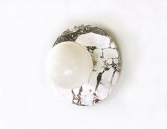 an overhead view of a marble knob on a white wall