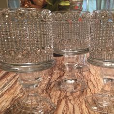 four crystal goblets are sitting on a table