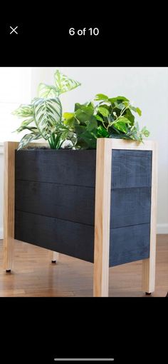 a planter is sitting on top of a wooden stand