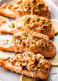 salmon fillets on a plate with lemons and parsley