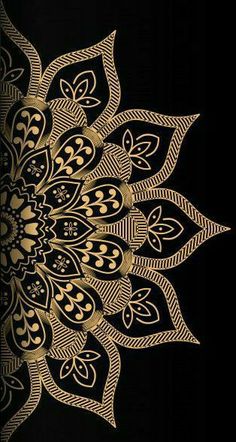 a gold and black flower on a black background with an intricate design in the center