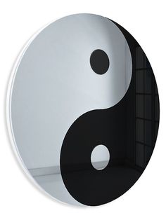 a mirror with a black and white yin symbol on it