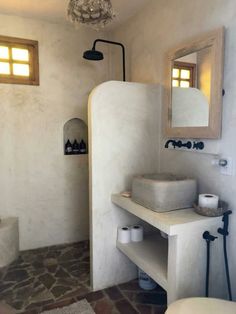 a bathroom with a sink, toilet and mirror