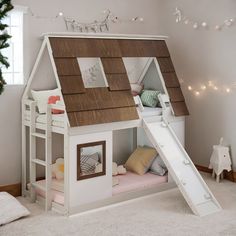 a child's bed with a slide in the shape of a house