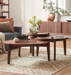 a living room filled with furniture and flowers on top of a table in front of a couch