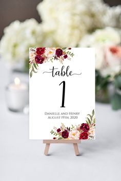 a table number sign with flowers on it