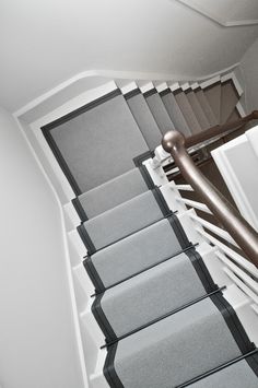 the stairs are lined with gray carpet and black trim