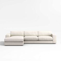 a white couch sitting on top of a white floor