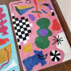 two colorful rugs sitting on top of a wooden floor next to eachother