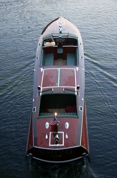 a small boat floating on top of a body of water